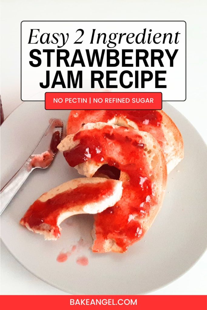 Homemade strawberry jam spread on a bagel on a white plate.