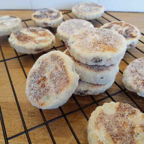 Showing baked welsh cakes on a cooling tray.