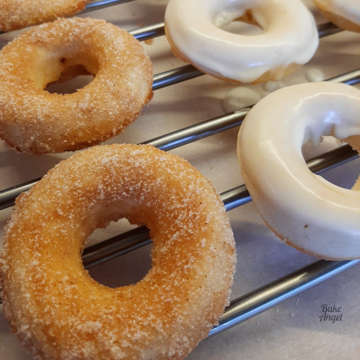 Close up of cinnamon sugar and glazed vegan ring donuts.