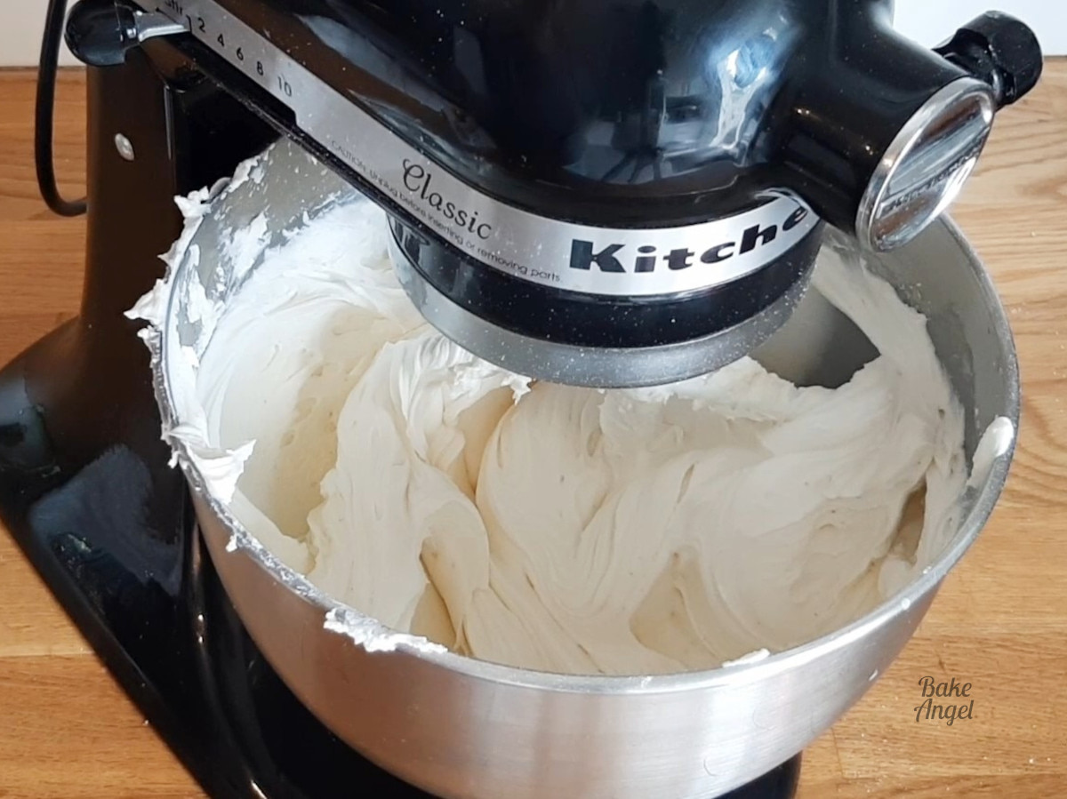 Showing vegan vanilla buttercream mixing in a stand mixer. 