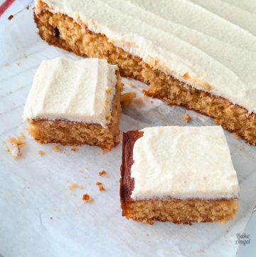 Close up of two slices of butterscotch cake on a cutting board.