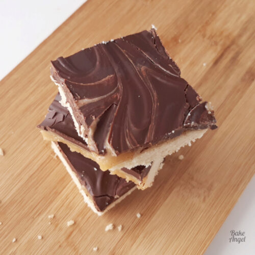A stack of 3 caramel millionaire shortbread squares.