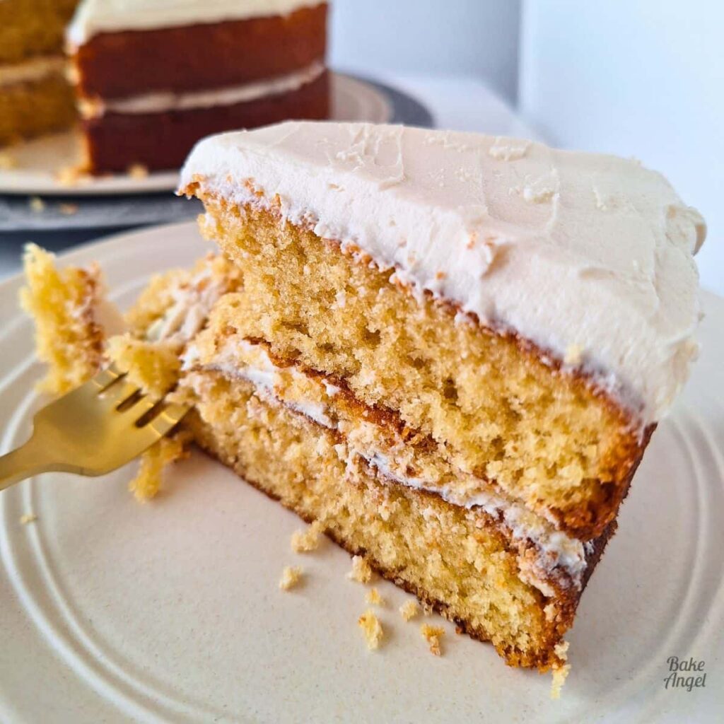 A slice of Dairy Free Coffee Maple Layer Cake decorated with coffee buttercream.
