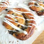 Close up of a pain aux raisin on parchment paper.