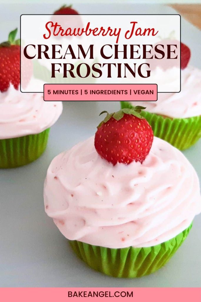 Close up of a cupcake topped with strawberry cream cheese frosting with a strawberry on top.