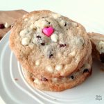 Close up of a stack of white chocolate cranberry cookies on a plate.