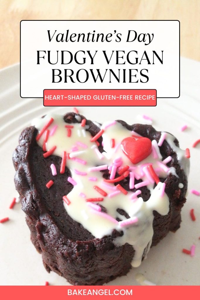 Close up of a mini heart-shaped vegan gluten-free avocado brownie, topped with melted white chocolate and sprinkles for Valentine's Day.