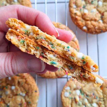 Close up of the inside of a funfetti cookie, showing the sprinkles and white chocolate chips.