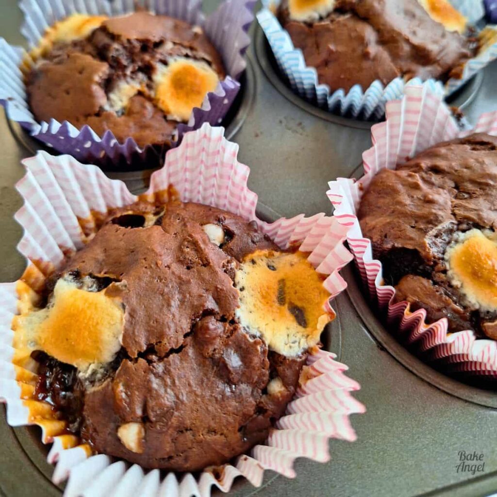Chocolate rocky road muffins packed with mix-ins, rich handheld dessert perfect for summer BBQ dessert tables.