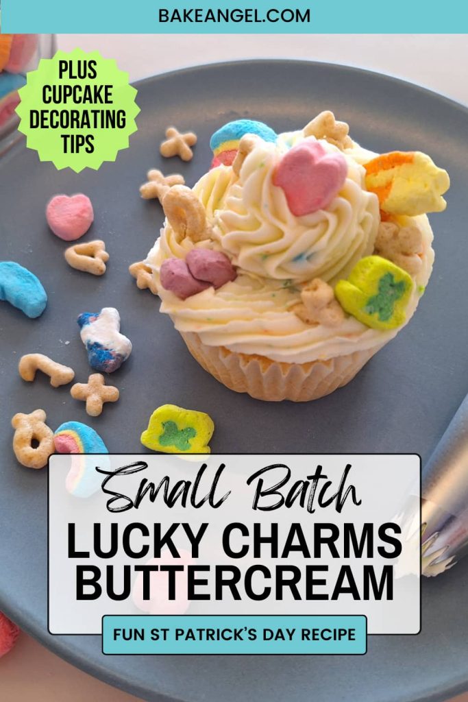 Small Batch Lucky Charms Buttercream piped in a swirl on a cupcake with extra marshmallows and cereal pieces on top.