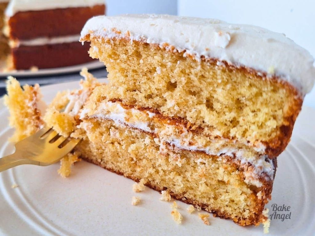 Close up of a slice of coffee layer cake filled and iced with vegan coffee buttercream frosting.