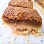 CLose up of a maple butter tart square on parchment paper.