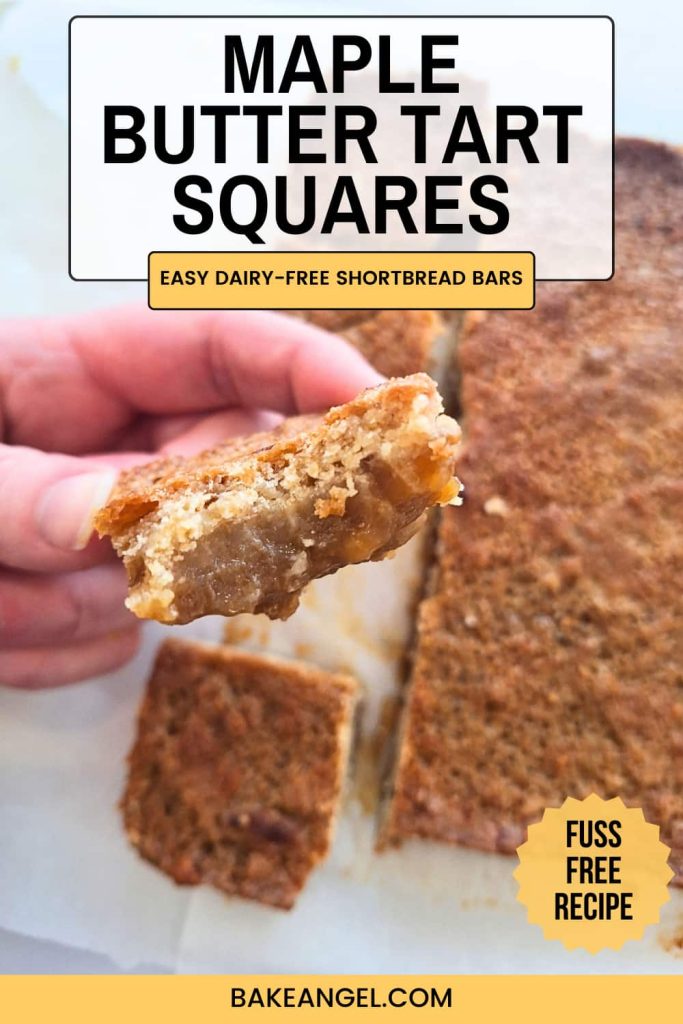 A small square of maple butter tart bars being held close-up to show the gooey layers.