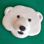 Close up of a fondat polar bear sugar cookie.