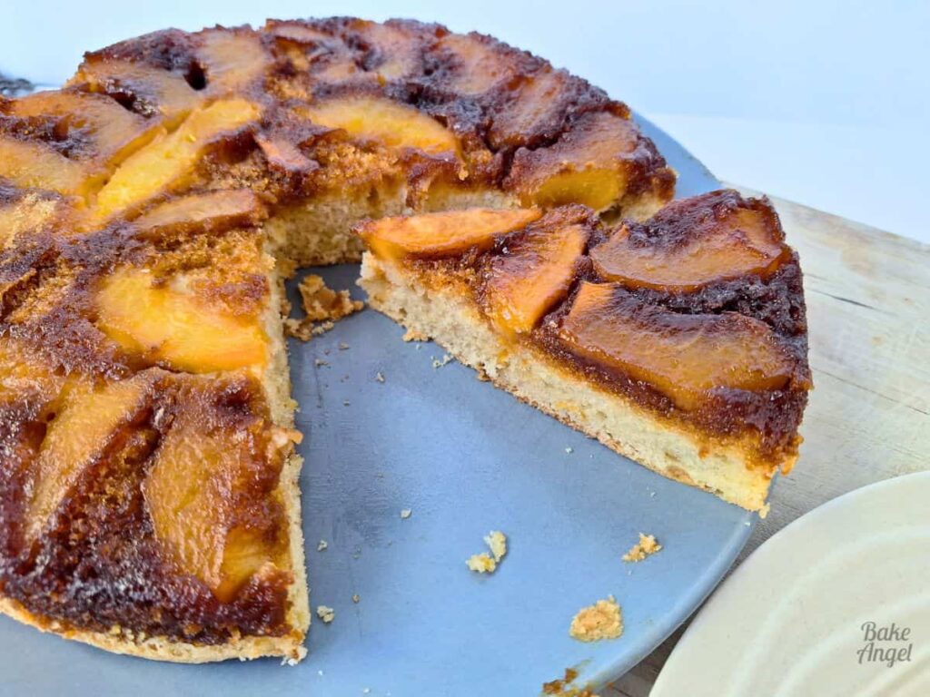 Slice of dairy free peach upside down cake cut on a plate.