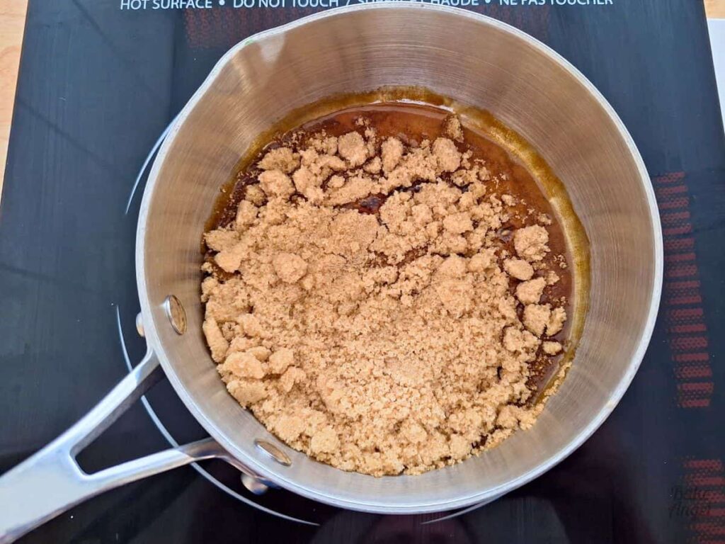 Brown sugar melting in a saucepan with plant based butter for caramel sauce.