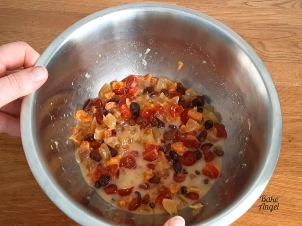 A mixture of dried fruit, melted butter and orange juice in a bowl.