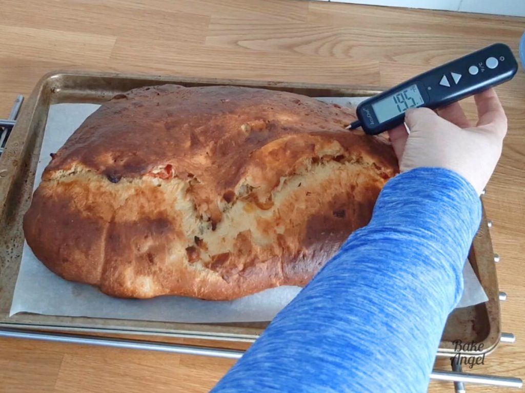 An internal thermometer showing 195F while inserted in to a freshly baked stollen loaf.