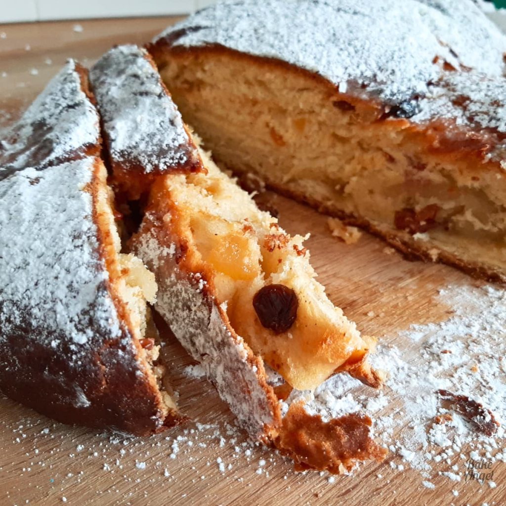 Close up of Dairy Free Christmas Stollen on a wooden board.