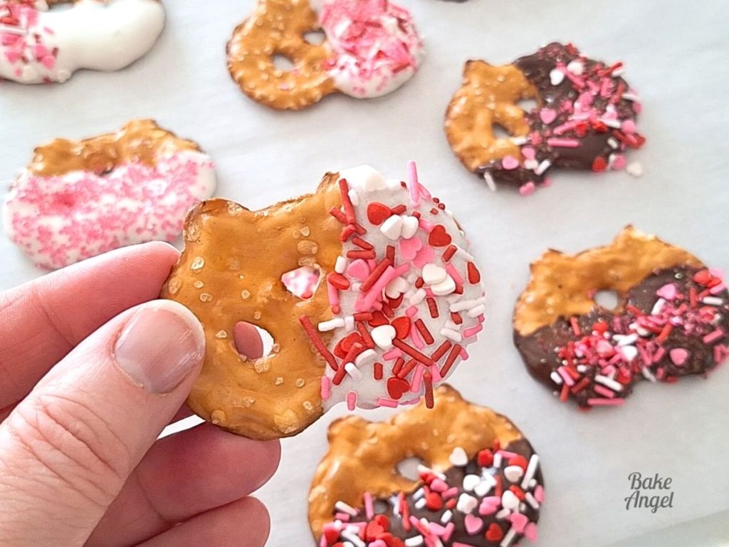 Close up of a white chocolate dipped pretzel with Valentine's Day sprinkles.