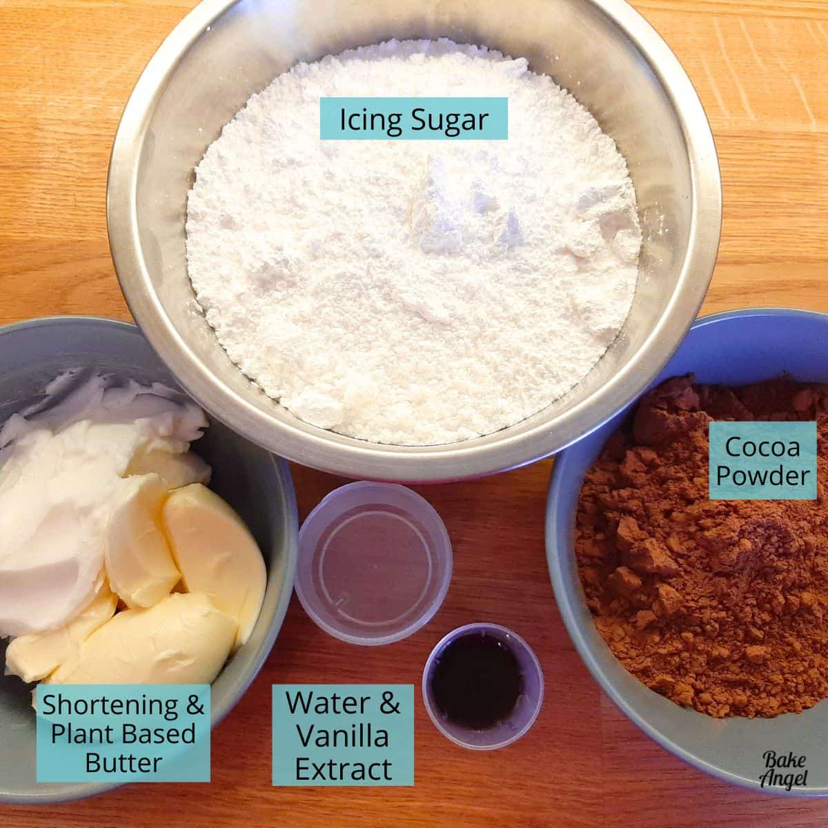 Ingredients to make stable chocolate buttercream: icing sugar, shortening, plant-based butter, water and vanilla extract, cocoa powder.