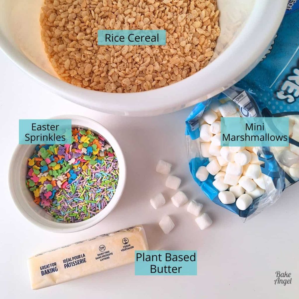 Ingredients laid out to make Dairy-Free Easter Rice Krispie Treats, includes rice cereal, a pot of Easter sprinkles, mini marshmallows, and a stick of plant based butter.