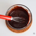 A small batch of Dairy Free Chocolate Ganache, with a whisk in the bowl.