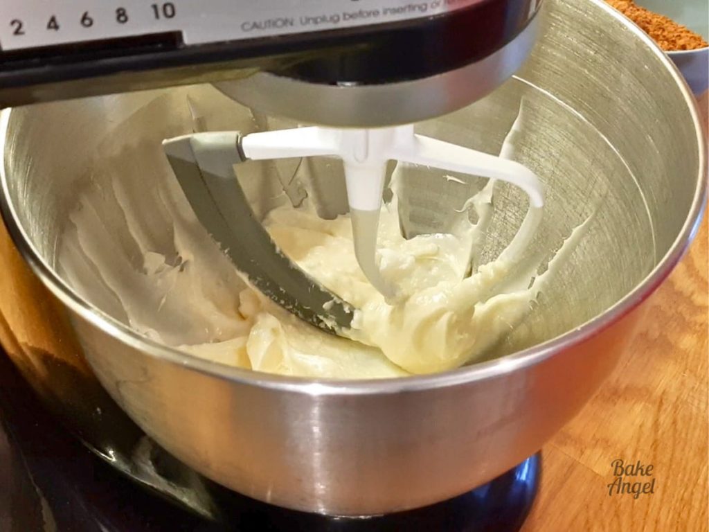 Shortening and plant-based butter mixing in a stand mixer bowl.