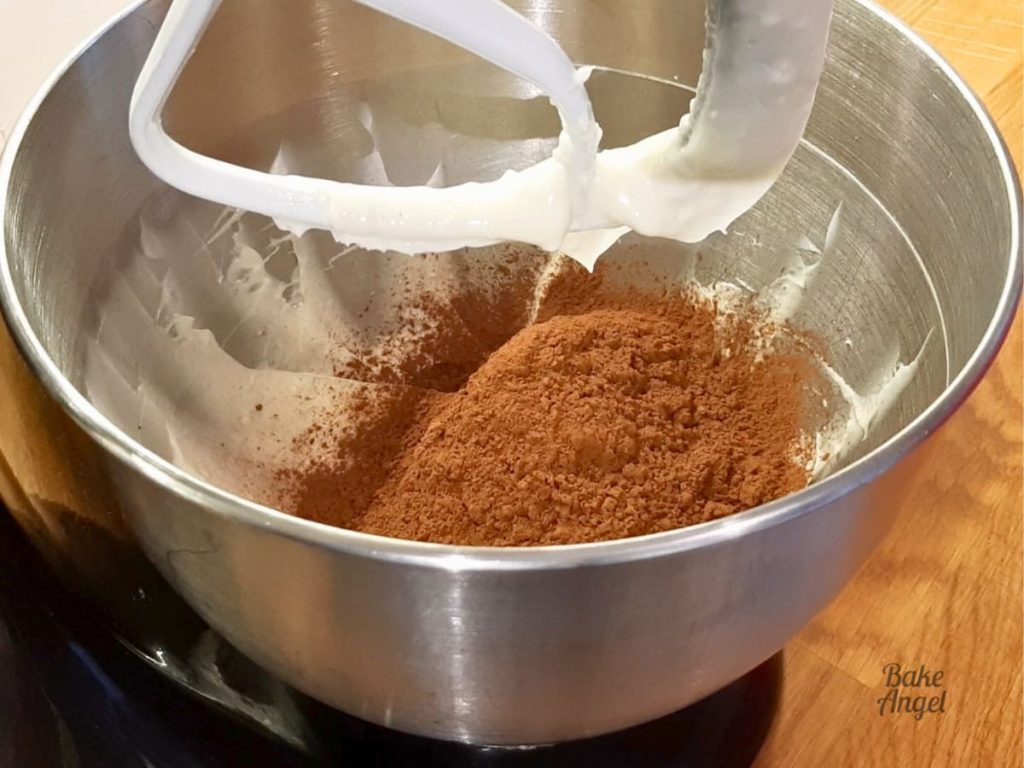 Cocoa powder added to the butter and shortening while making chocolate buttercream.
