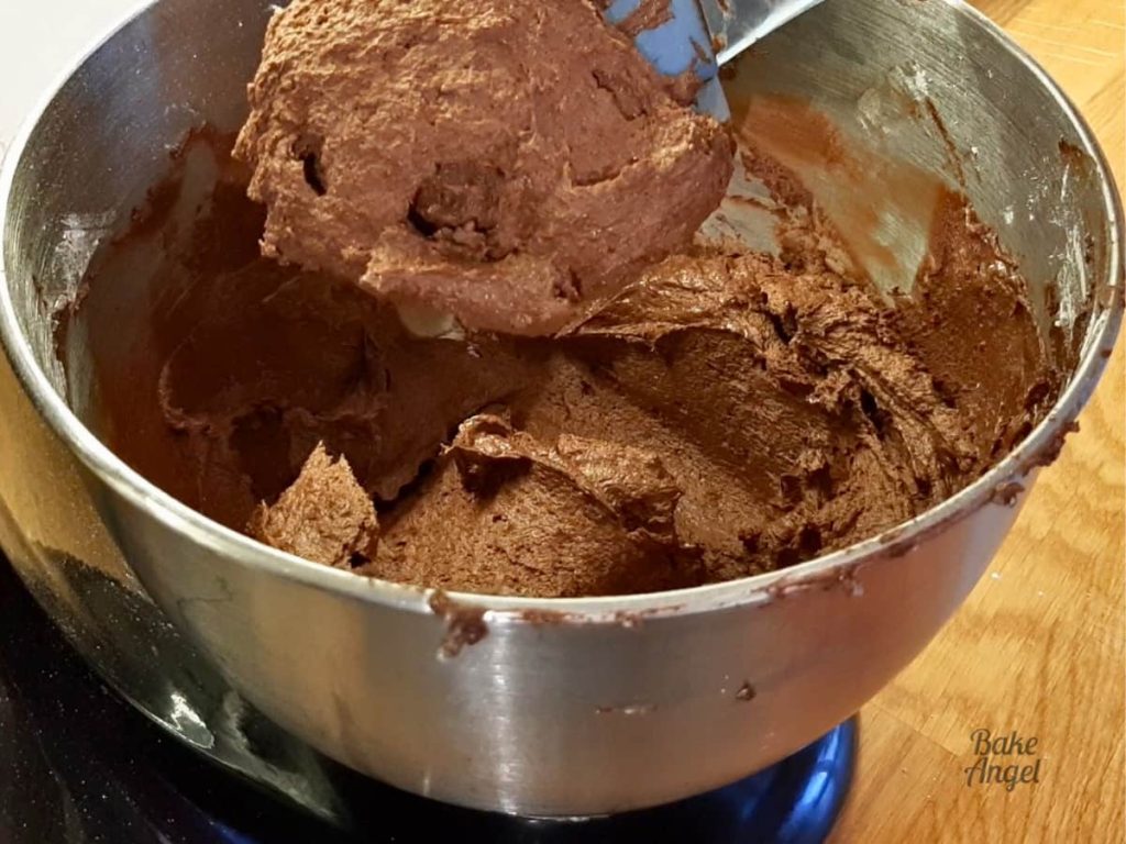 A finished batch of stable chocolate buttercream in a stand mixer bowl.