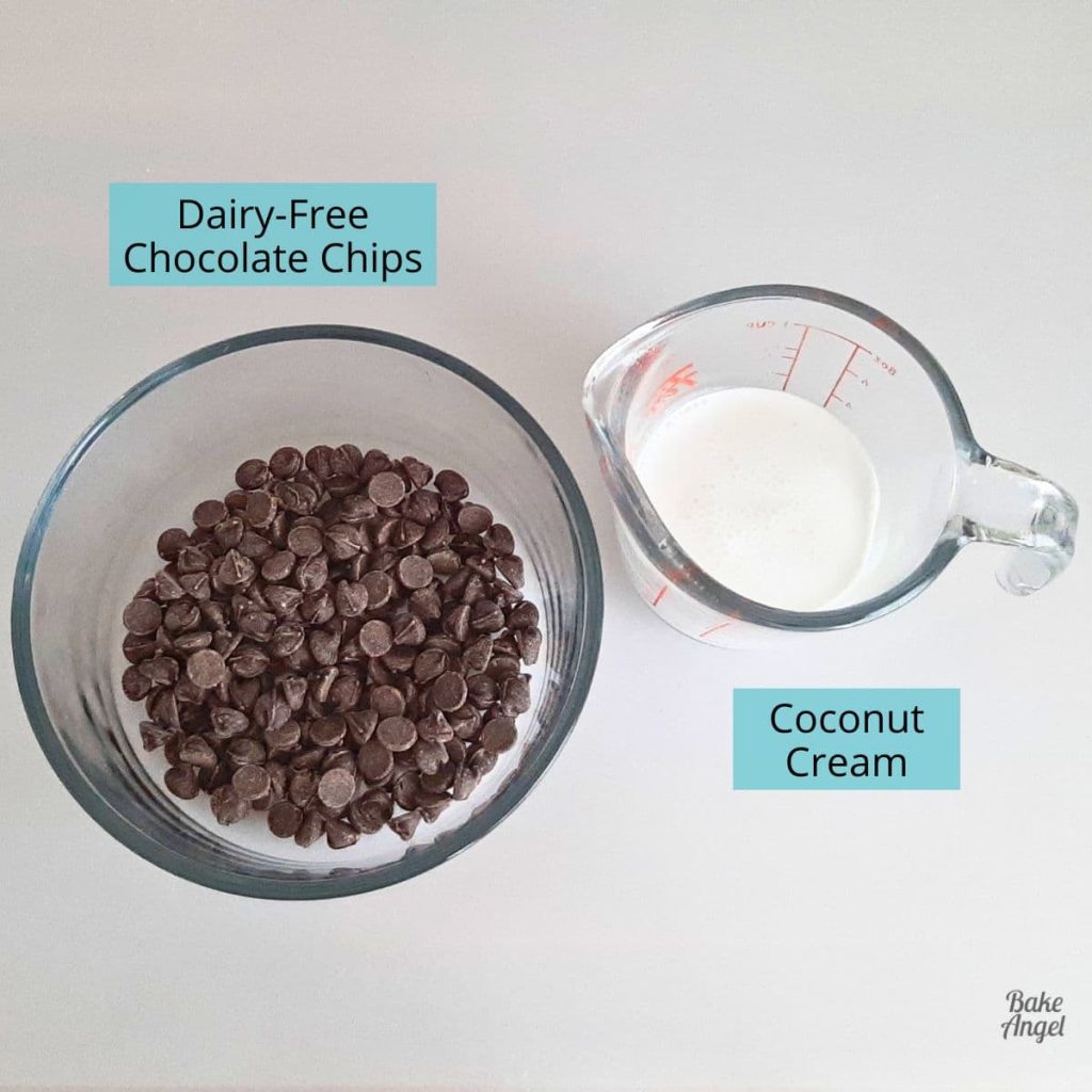 A small bowl containing dairy free chocolate chips, and a small jug containing coconut cream.
