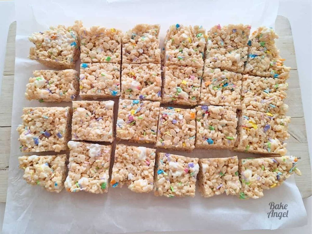 A slab of Dairy-Free Easter Rice Krispie Treats cut in to 24 pieces on parchment paper.