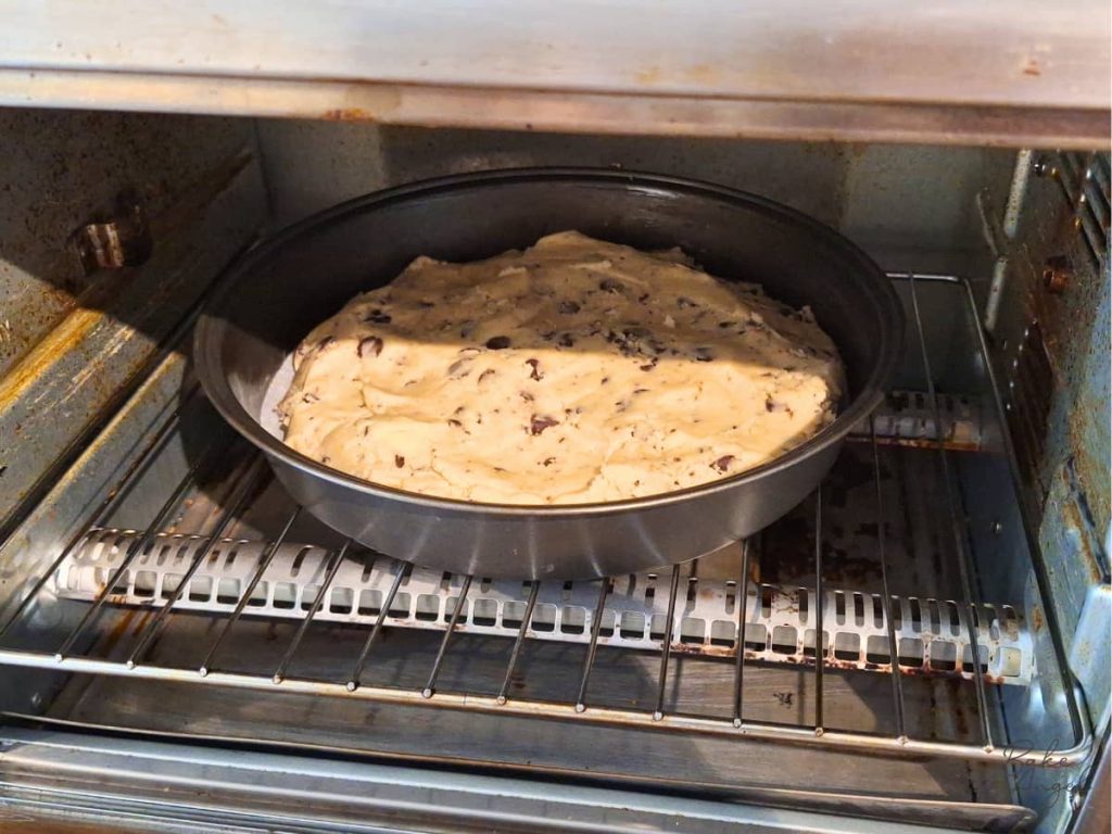 Chocolate chip cookie cake baking in toaster oven for small batch baking