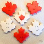 6 Maple Leaf shaped sugar cookies decorated with royal icing.
