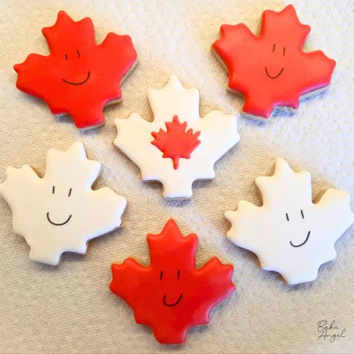 6 Maple Leaf shaped sugar cookies decorated with royal icing.