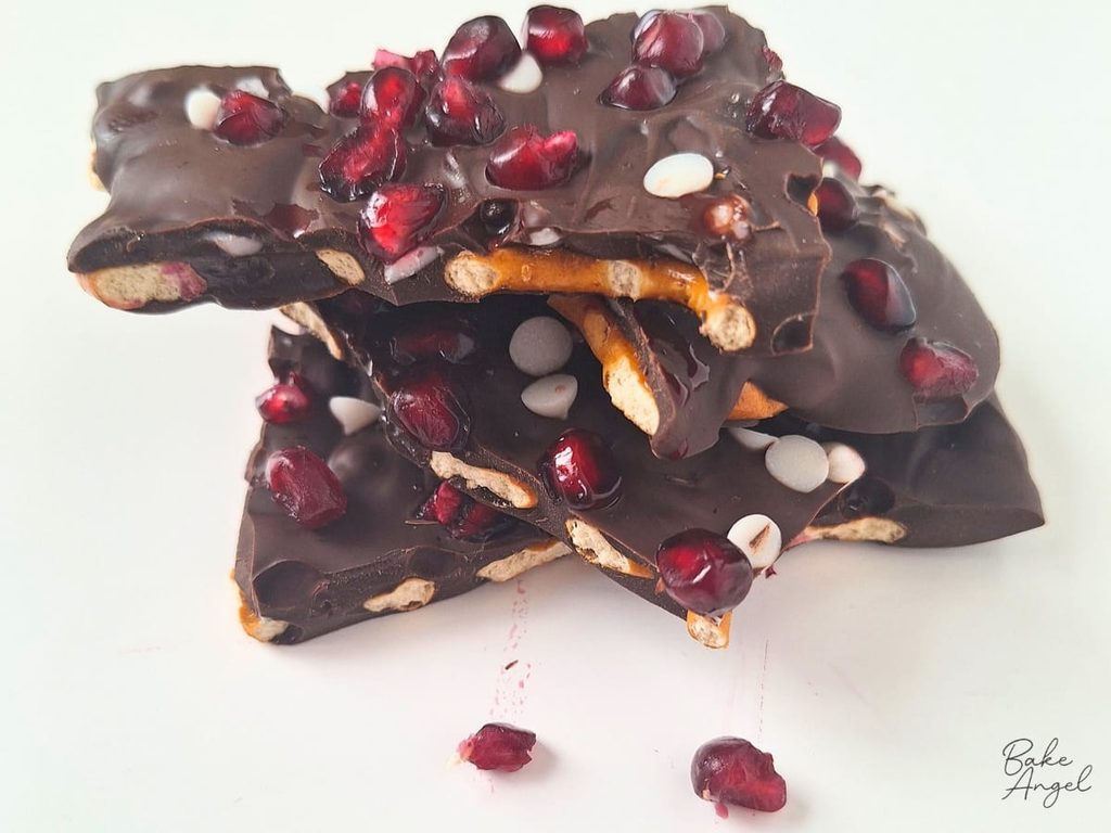 A stack of pieces of vegan pomegranate pretzel bark.