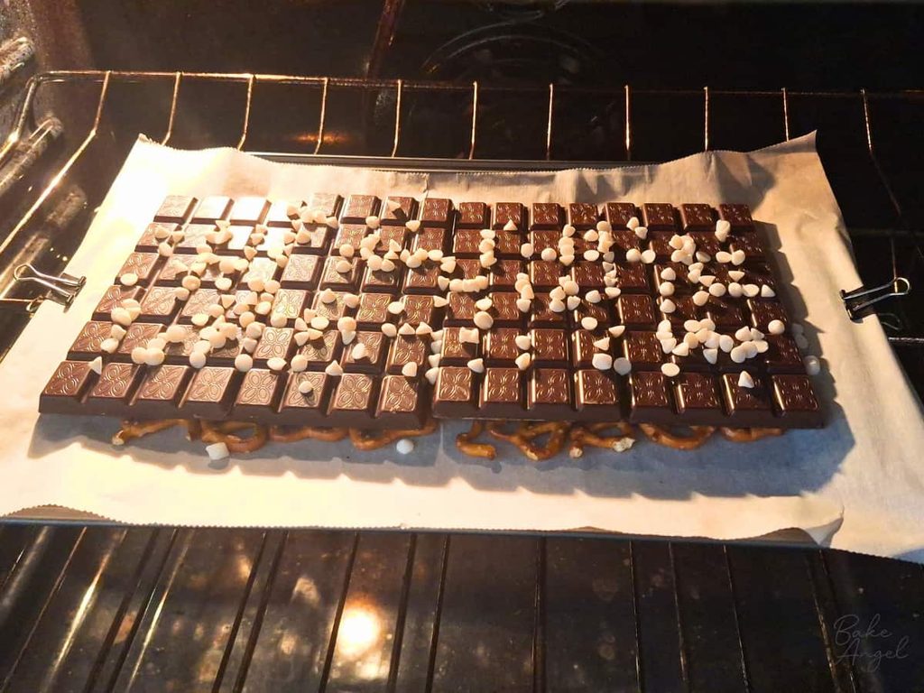 A tray of pretzel bark being melted in the oven.