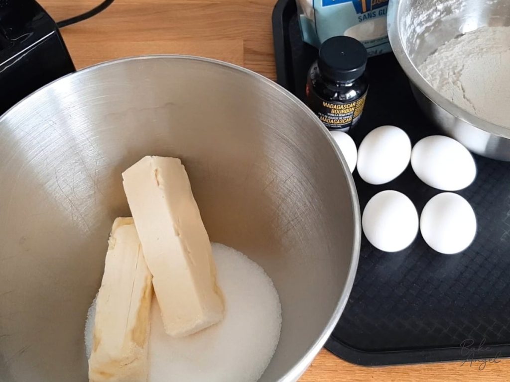Butter and sugar in a mixing bowl to make cake batter.