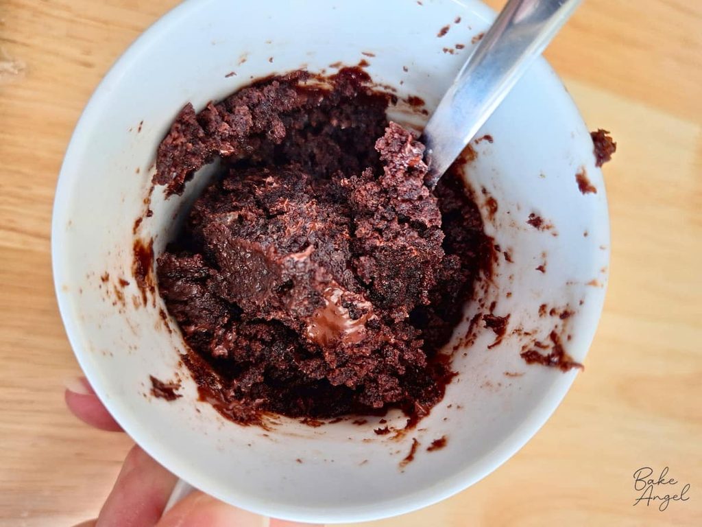 Close-up of a freshly made chocolate mug cake, showing its soft chocolate interior.
