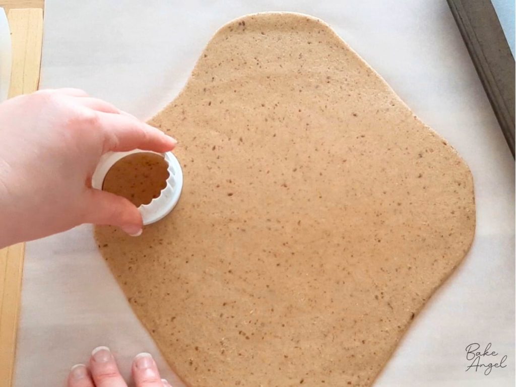 Cutting round digestive biscuits from rolled dough