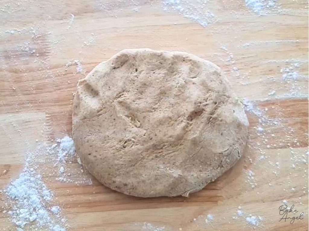 Digestive biscuit dough shaped into a flat disc before chilling