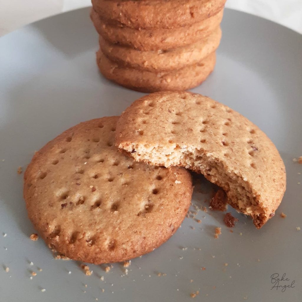 Homemade dairy-free digestive biscuits stacked on a plate