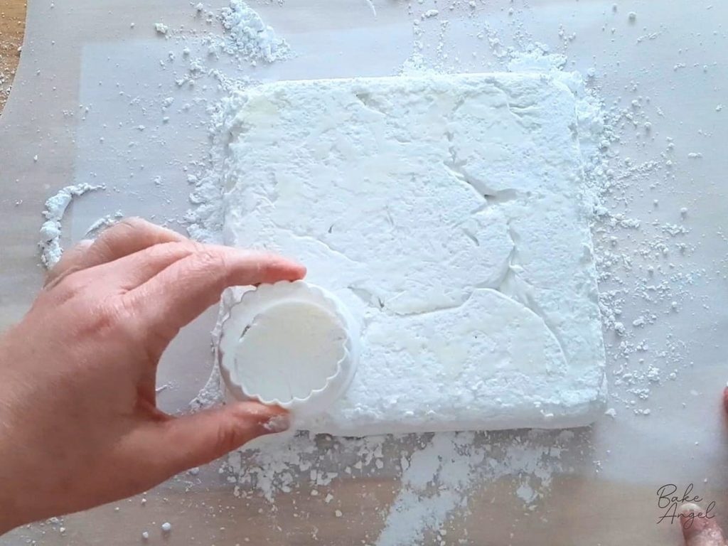 Using a circle cutter to cut homemade marshmallows.