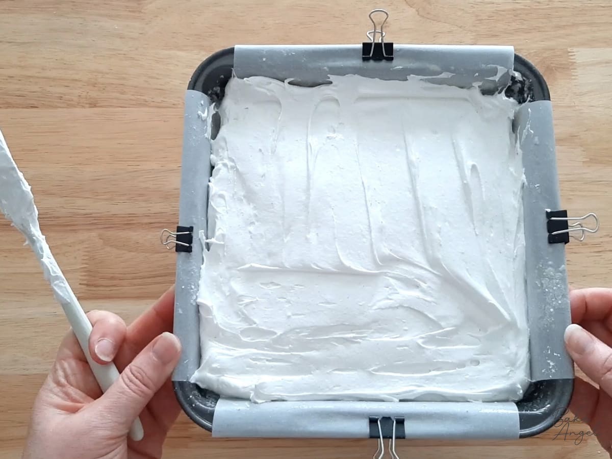Homemade marshmallow mixture spread evenly in the lined 8 x 8 inch baking pan.